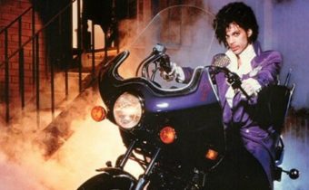 Photo of the musician Prince on a purple motorcycle