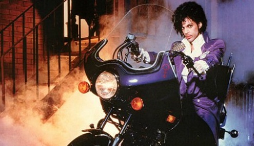 Photo of the musician Prince on a purple motorcycle