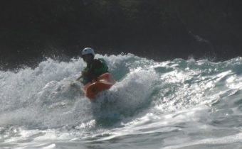 Photo of kayak surfer on river in California. A good kayaker is like a family dynasty that can ride the waves on the open water.